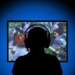 Silhouette playing video games on pc at home