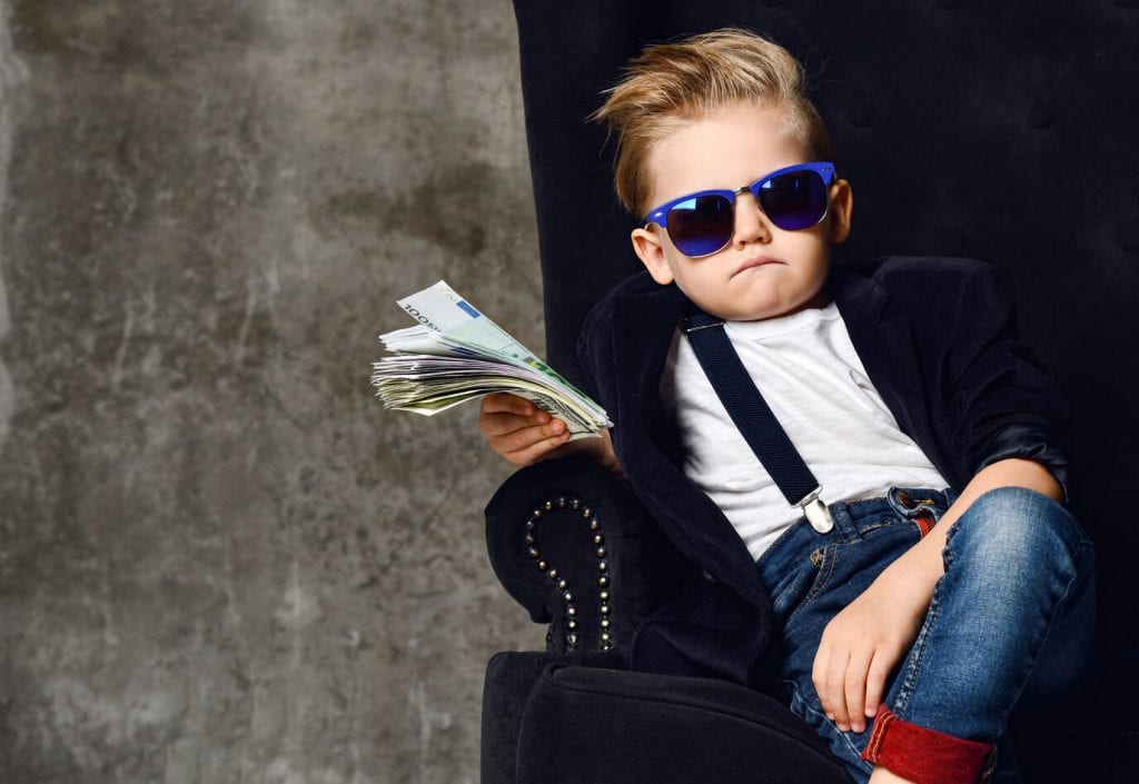 Kid sitting with wad of cash