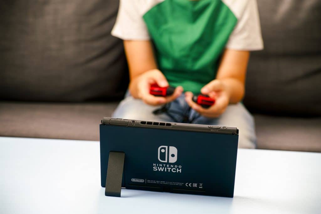 Tambov, Russian Federation - June 22, 2019 Kid playing Nintendo Switch video game console.