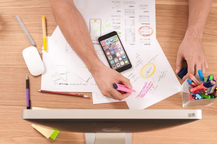 Desk with marketing ideas and computer