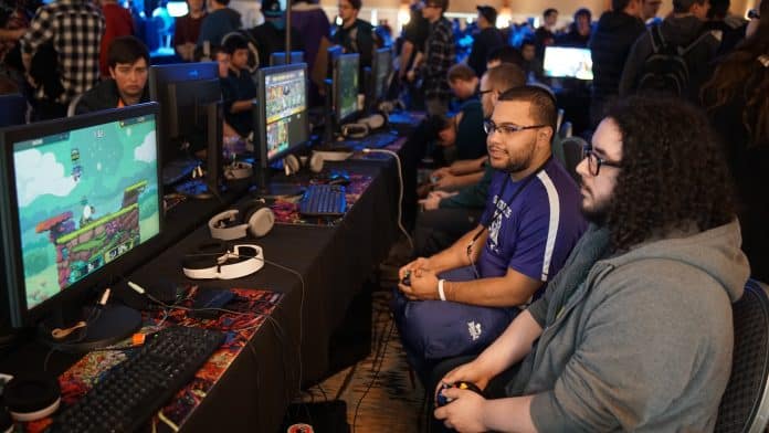 young people playing retro video game consoles