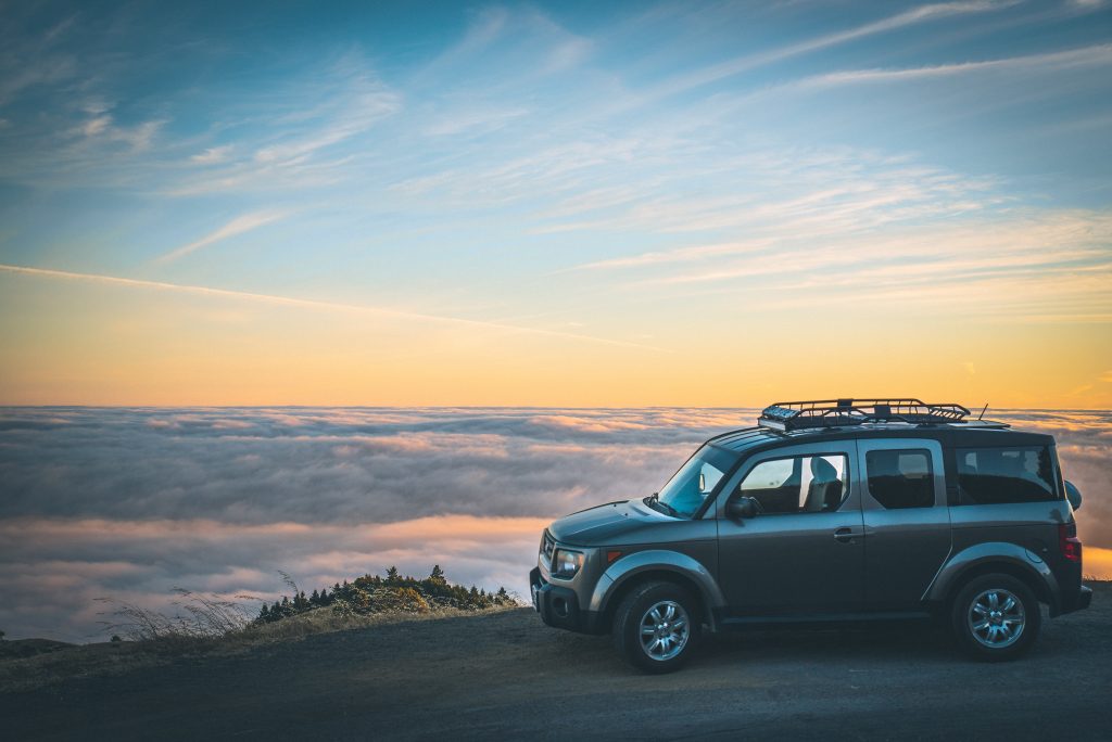 car looking over misty canyon